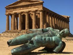 green sculpture and temple ruins in Valley of the Temples, Sicily