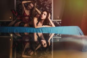 Photo session of two girls on a bed