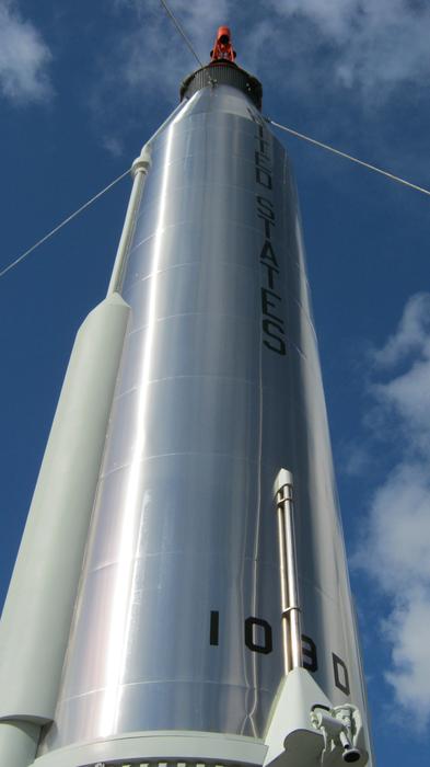 Low angle shot of the shiny Gemini Rocket, under the blue sky with clouds