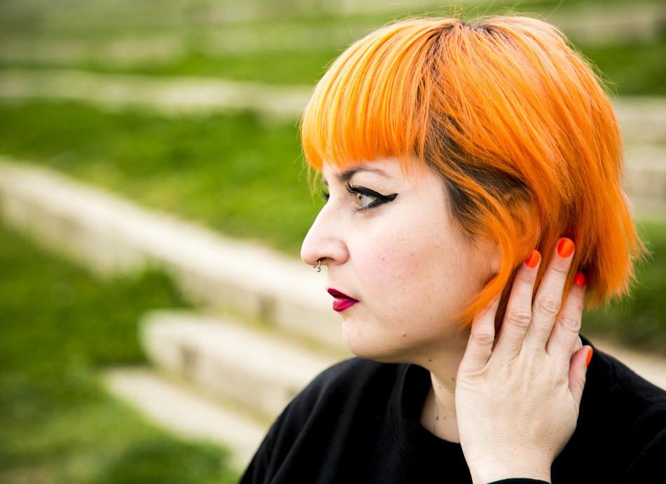 woman with orange hair in nature on a blurred background