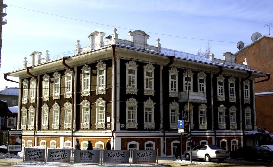 Beautiful, old building on the street in Novosibirsk, Russia, under the blue sky with clouds