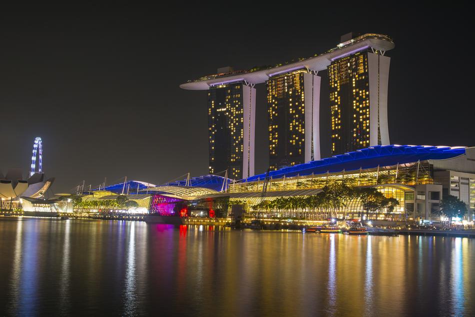 Coast of the bay with 'Marina Bay Sands' and colorful lights, in Singapore, at the night