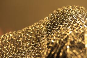 Close-up of the shiny, gold texture in light