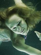 Portrait of the girl with open eyes, underwater