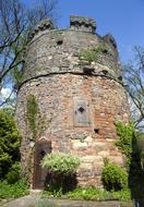 Beautiful Witches' tower among the plants, in Frankenberg, Hessen, Germany, under the blue sky with clouds