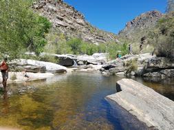 river in the rocks with people landscape