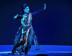 Colorful, traditional, Indian dancer on the stage, in blue lights