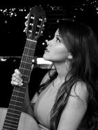 girl with guitar in black white background