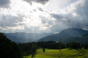 The sun and the clouds by the meadow