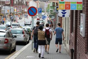 People walking on the street with colorful signs and cars