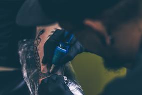 guy draws a tattoo on his body