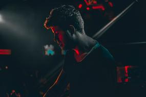 young Man on stage in darkness