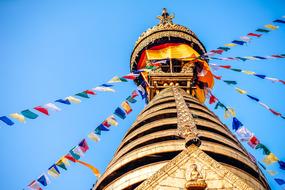 multicolored flags on the tower of the cathedral