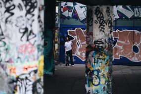 man standing near Structure Building Wall