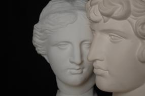 female and male heads face to face, sculpture