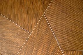 Close-up of the brown, wooden floor with shapes