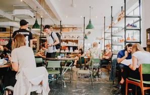 People in the cafe, wiith the tables, chairs and other furniture