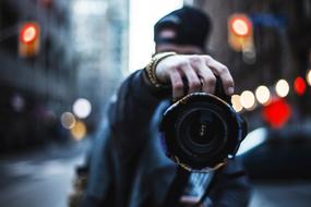 man with Canon Camera in city, Lens close up