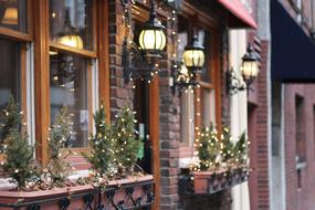 christmas lights at windows of brick House