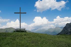a large cross on a background of white clouds