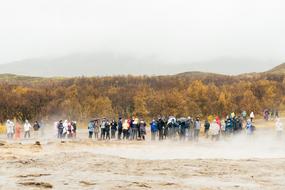 a crowd of people on the field in the rain