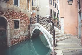 Beautiful cityscape with the stairs above the canal, among the buildings