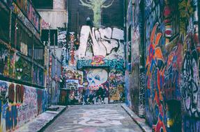 men sleep near the wall with graffiti