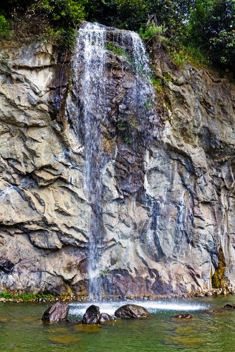 cute waterfall en rocks landscape
