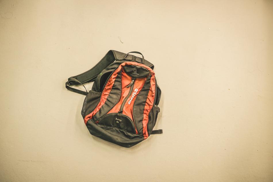 red black backpack on the floor