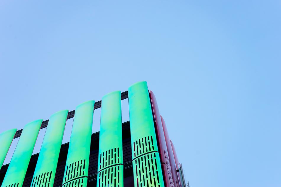 Low angle shot of the colorful building, under the blue sky