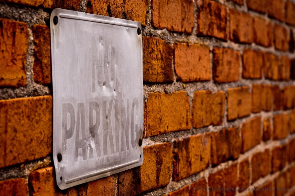 No Parking Sign on Brick wall