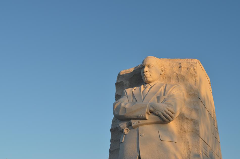 Statue of the man, in the rock, in light, at blue sky on background