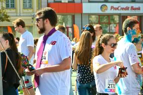 People in colorful paint, on the street in Kiev, Ukraine, in sunlight