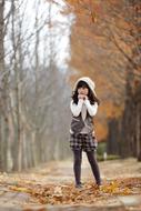 charming asian Girl in park at Autumn