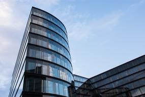 Shiny buildings with windows, in Vienna, Austria, under the blue sky with clouds