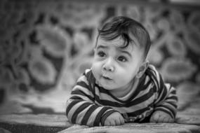 Black and white portrait of the cute, curious baby