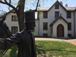 statue of Lincoln in the park in front of the building in Washington