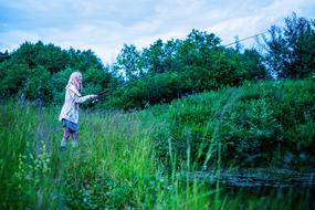 Girl Fishing green grass pond