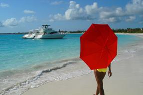 red umbrella with a girl on the beach