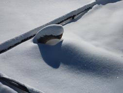 the snow roof of the house is white