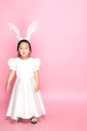 Child Merry white dress pink background