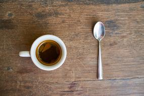 sweet coffee on the table with a spoon