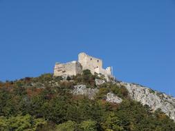 stone castle with trees in the mountains