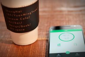 cell phone next to the coffee