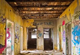 Interior of the old building, without the doors, and with colorful graffities