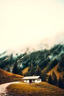 Beautiful landscape with the cottage on the colorful mountains, in fog, in Germany