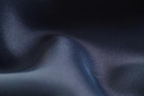 Close-up of the blue, dark fabric with wave folds