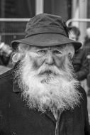 monochrome photo of an elderly man with a gray beard
