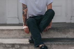 man with tattoos on his arms