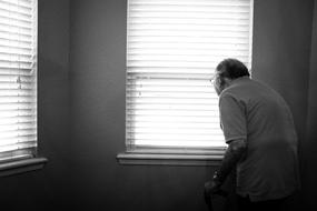 black and white, elderly man at the window